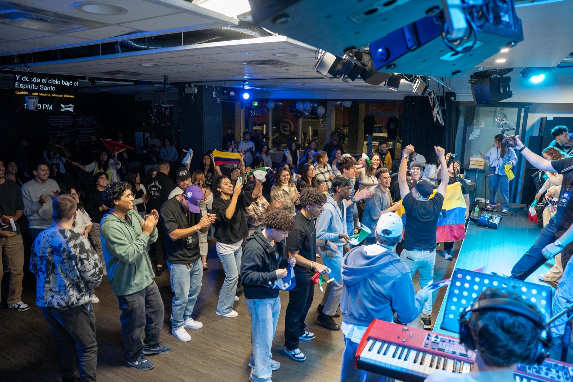 People celebrating together with flags at a Worship Nights gathering