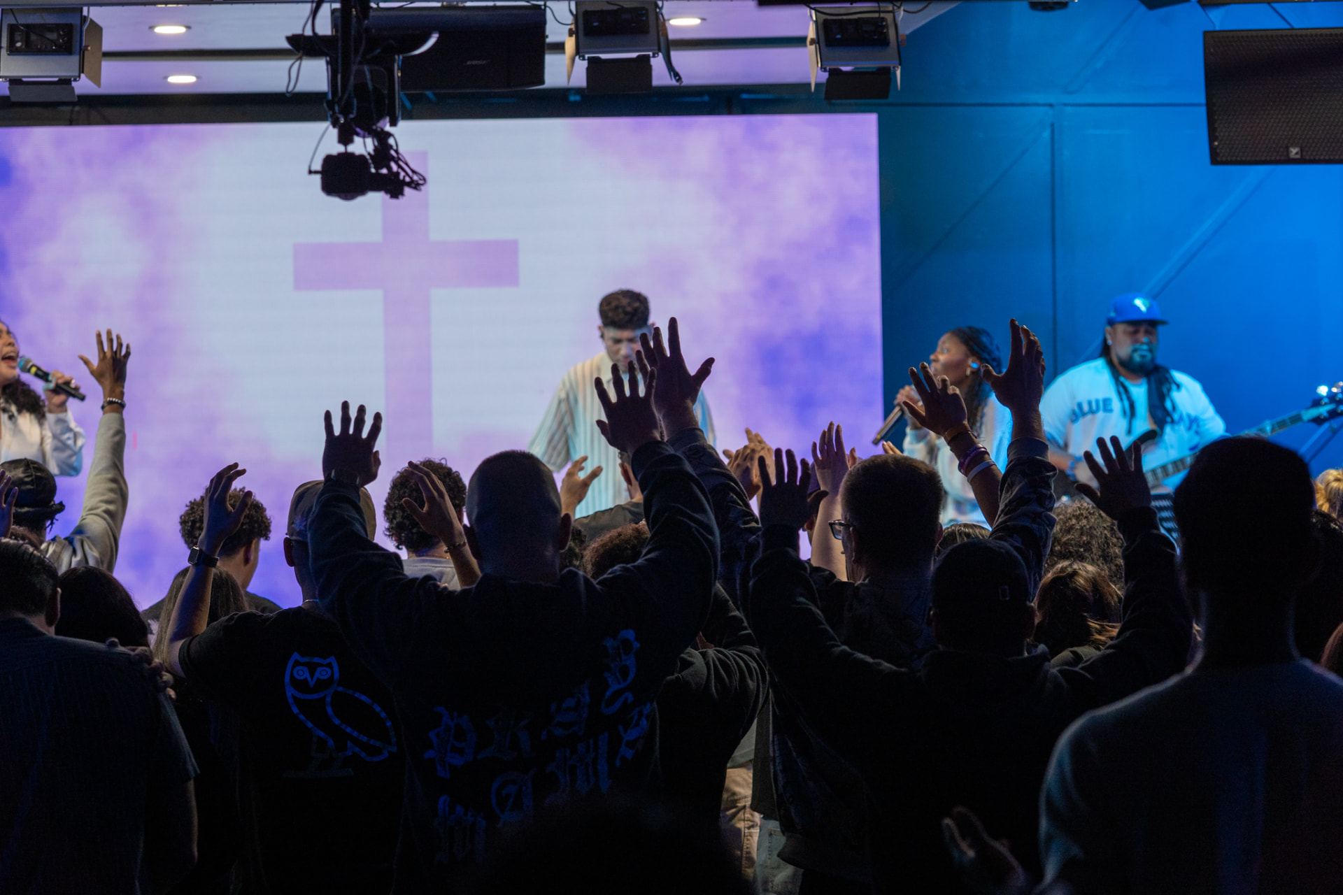 Hands raised in worship during a Worship Nights service